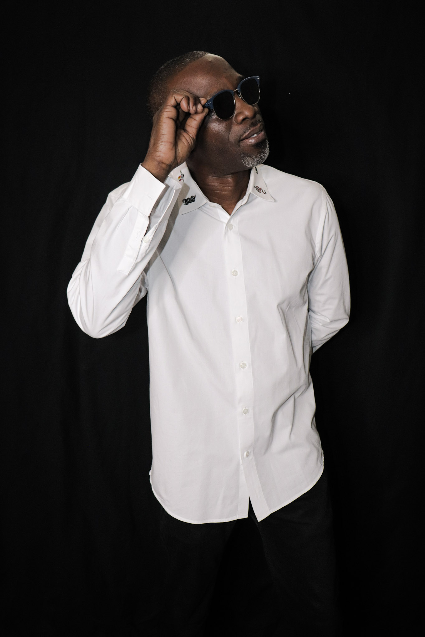SURVIVORSOUNDS DJ in a crisp white shirt and sunglasses